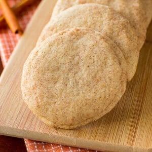 Snickerdoodle cookies laid out on a wooden board on the table.