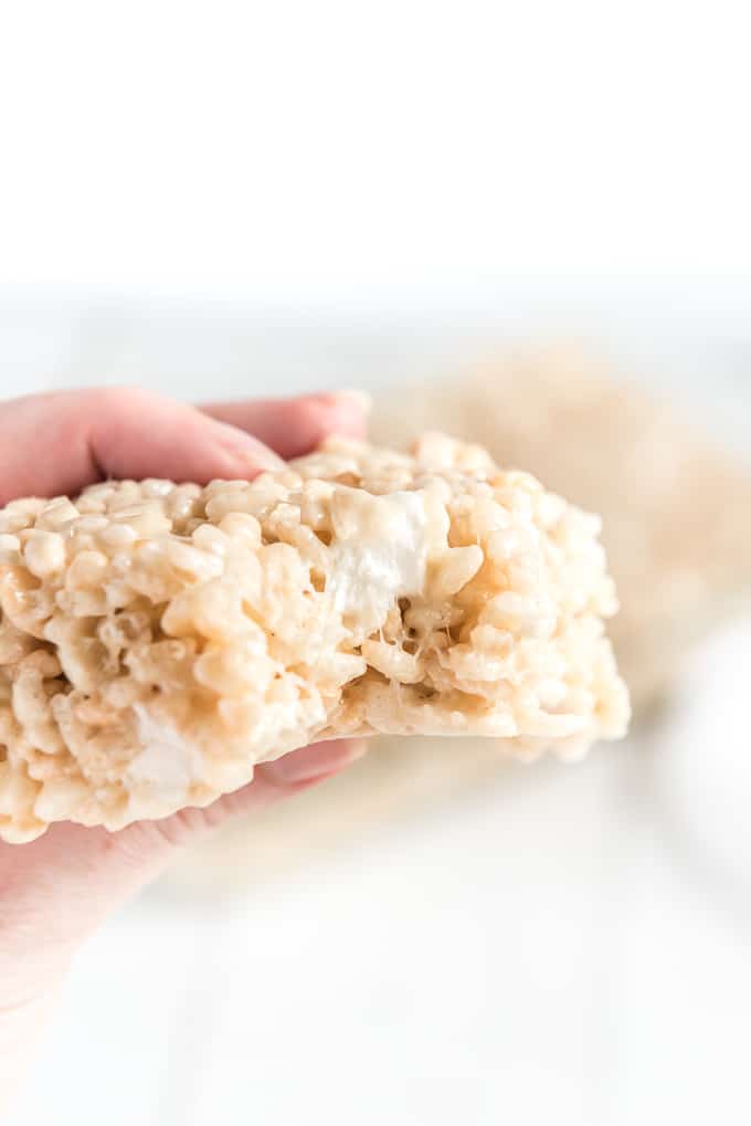 rice krispie treats in hand with bite missing