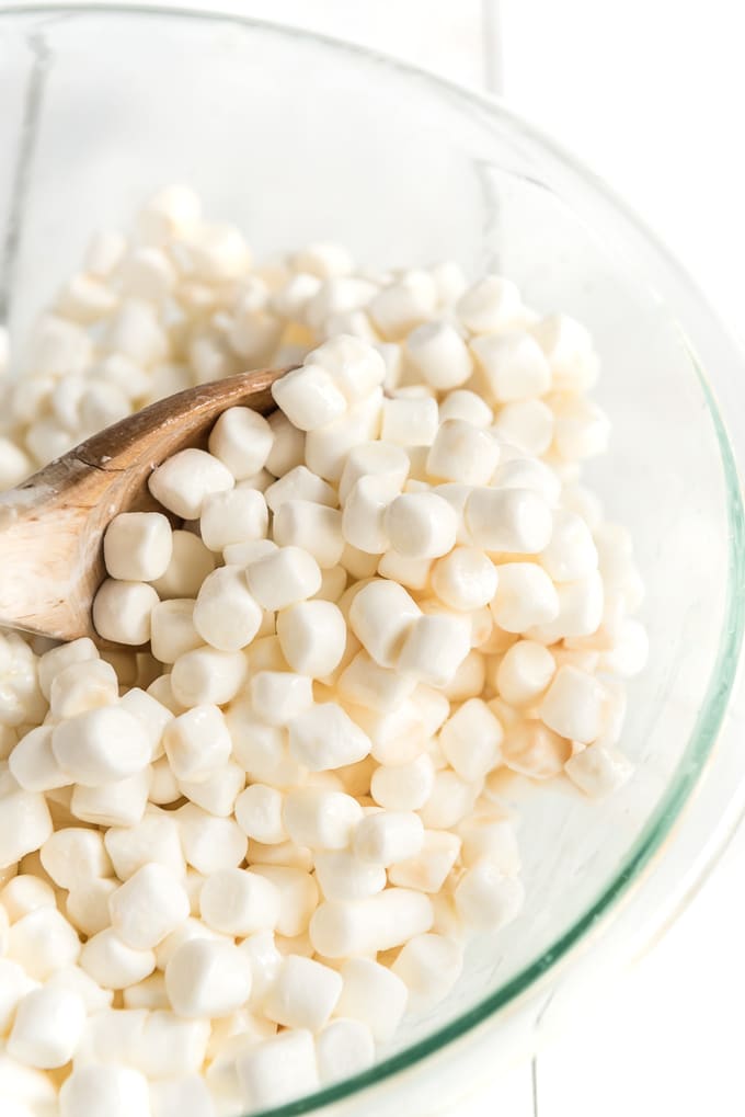 stir marshmallows in bowl for rice krispie treats