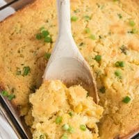 corn casserole recipe being spooned out of dish