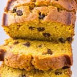 Pumpkin chocolate chip bread cut into slices with some falling over to show inside.