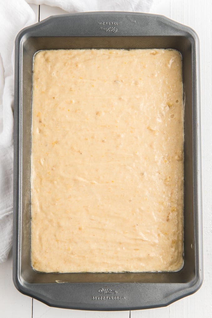 Banana cake batter is placed in a baking dish.