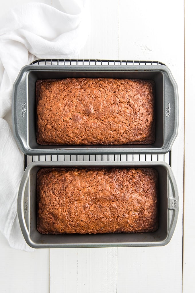 Two loaves of zucchini bread are completely baked in pans.