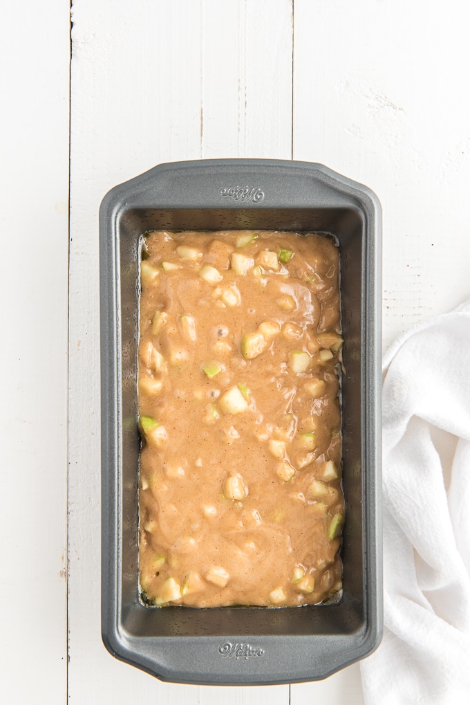 Batter has been poured into a loaf pan.