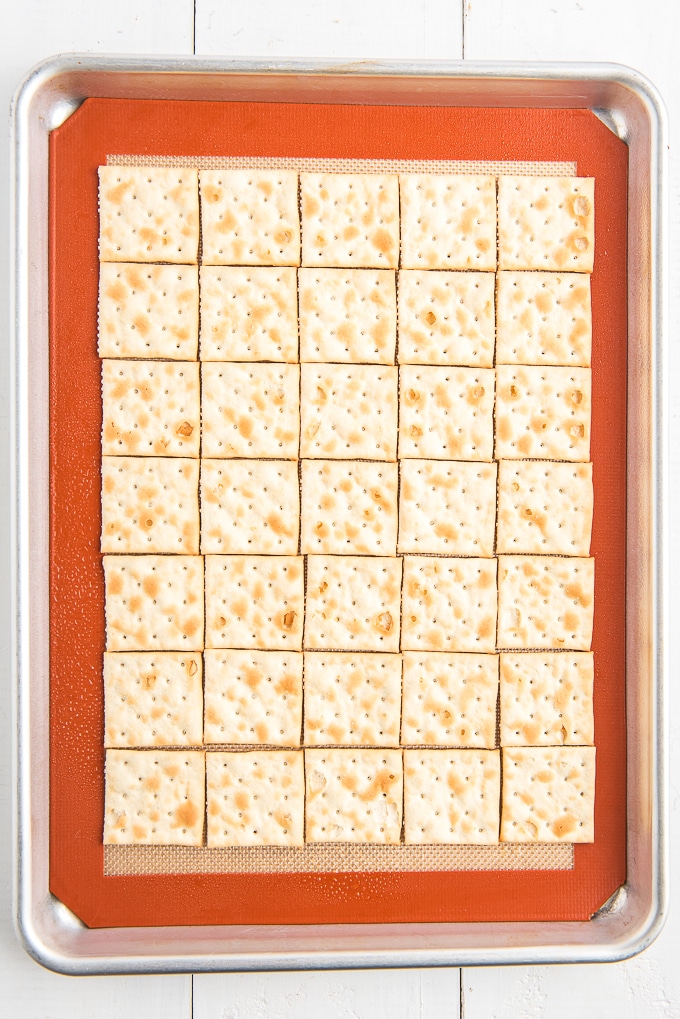 saltine crackers on baking sheet