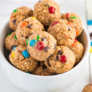 Bowl of no bake energy balls made with M&Ms.