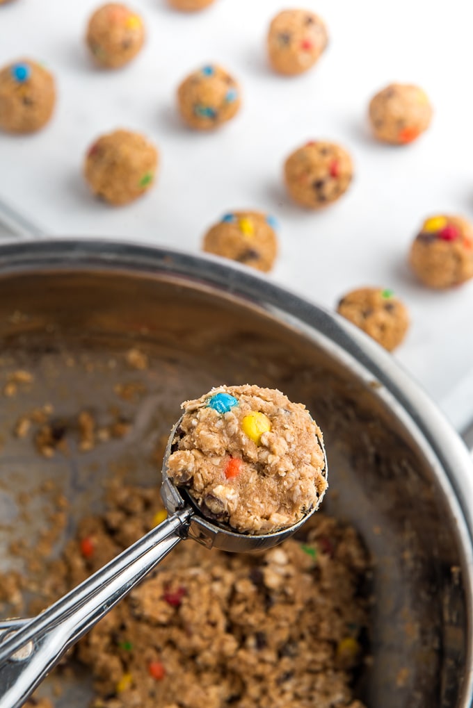 No Bake Energy bites scoop out of mixing bowl. 