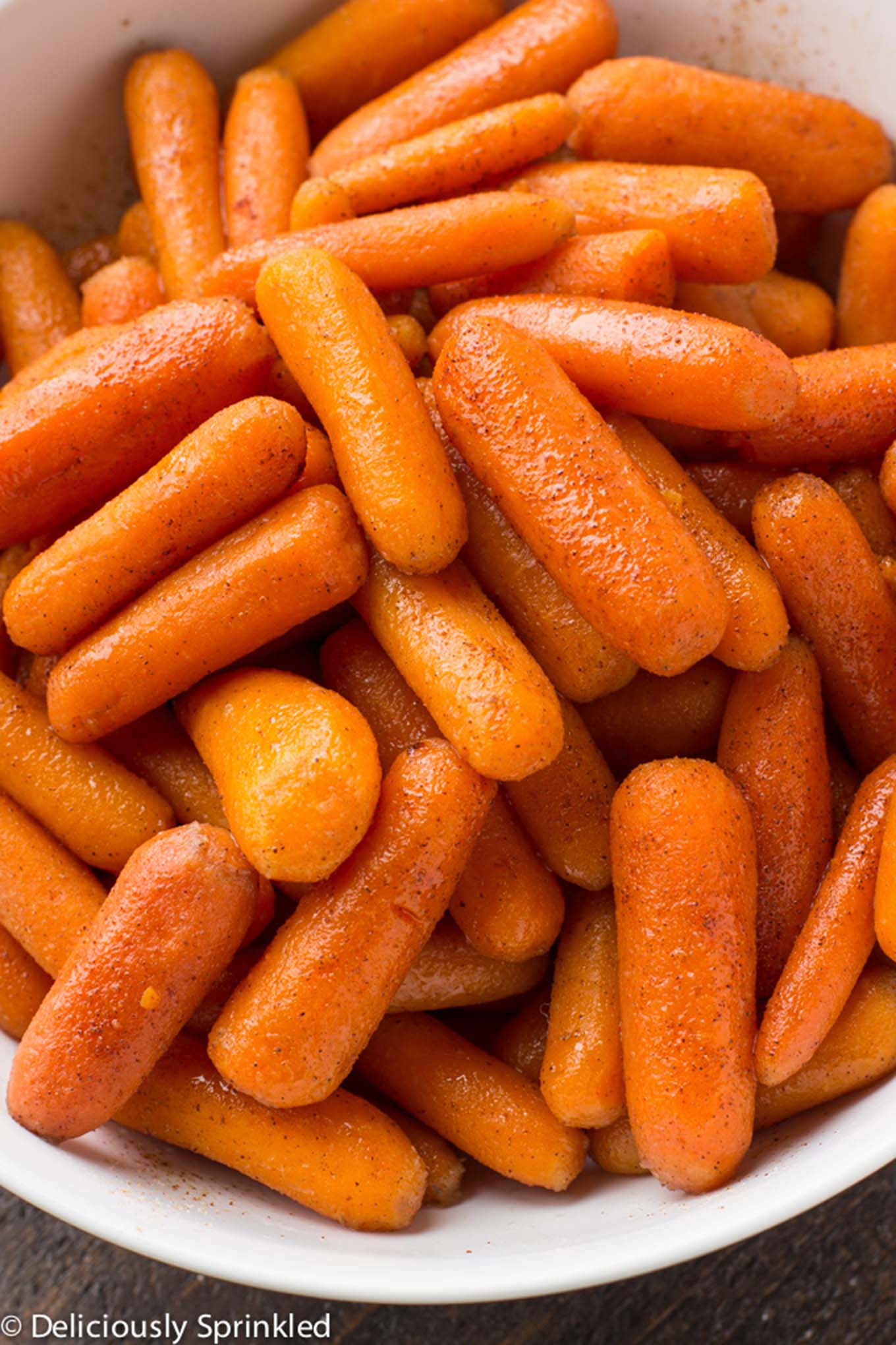 Instant Pot Glazed Carrots in a white bowl/ Brown sugar carrots only use simple ingredients and only takes less than 10 minutes to make. Perfect holiday side dish that everyone will love. 