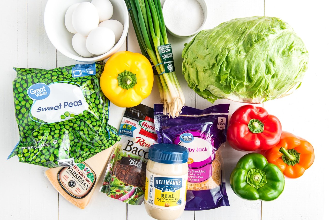 Ingredients to make a classic seven layer salad on the table.