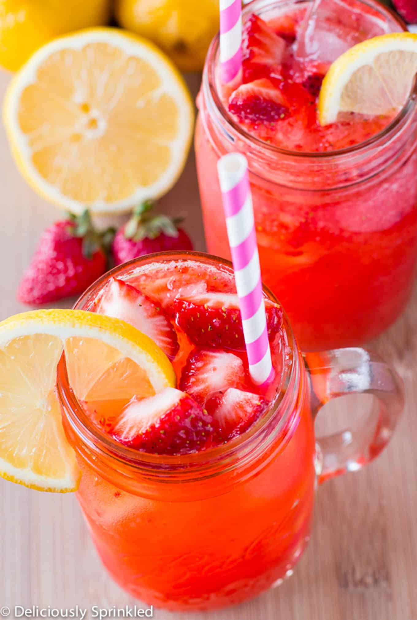 Strawberry Lemonade in a mason jar with straw. / Fresh strawberry lemonade made with only 4 simple ingredients. 