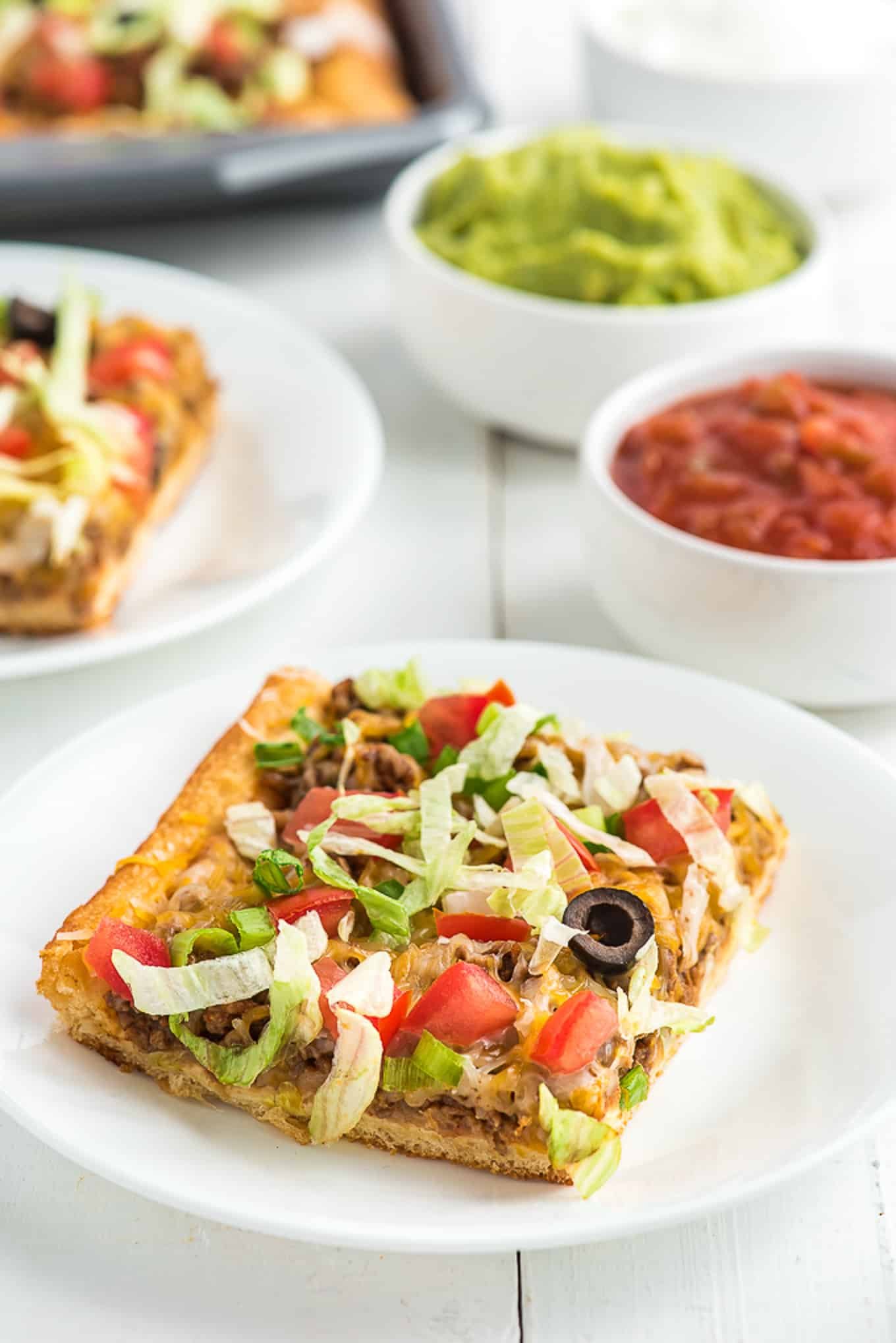 slice of taco pizza on a plate./
