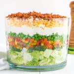 Classic 7 layer salad in a large bowl.