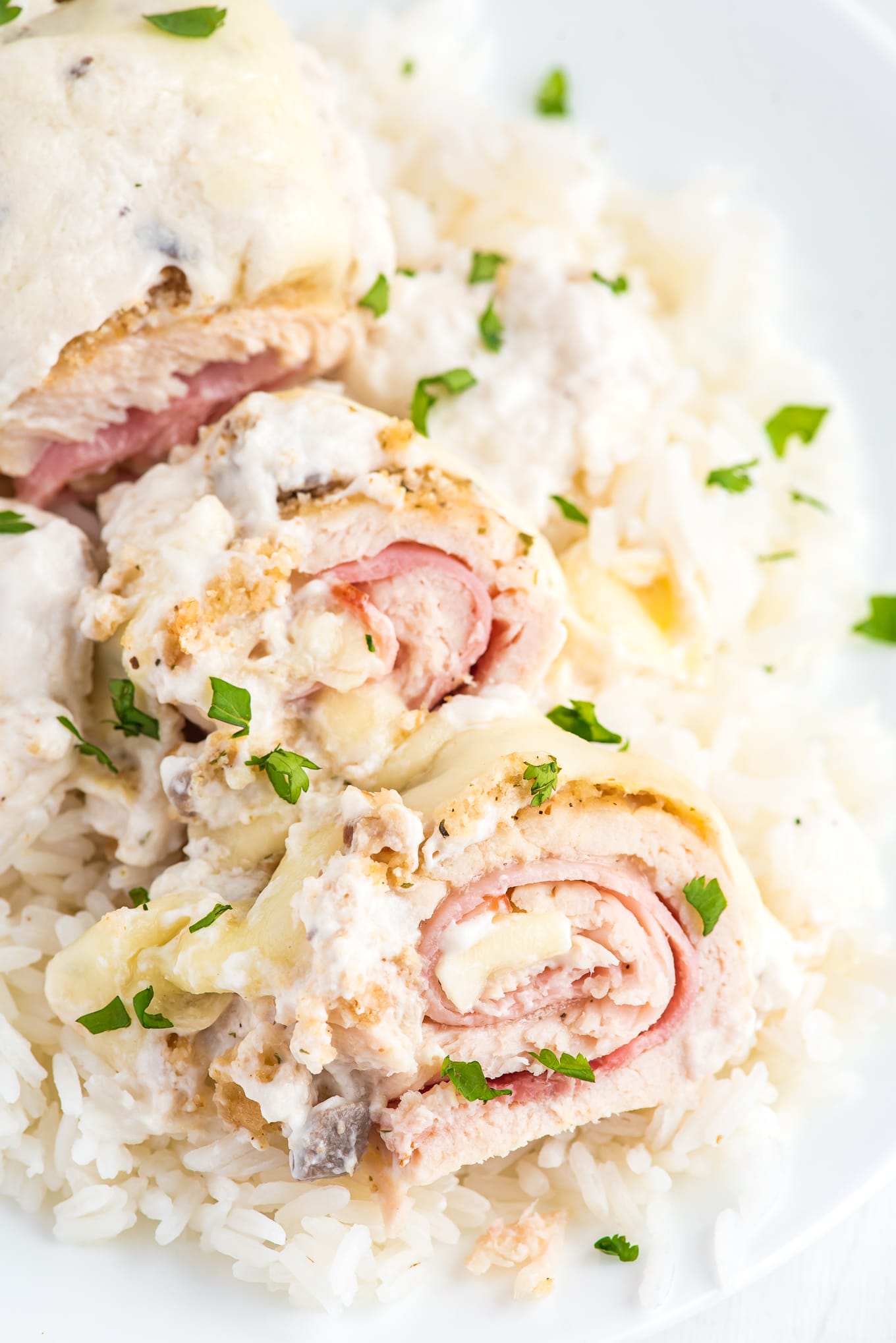 Easy chicken cordon bleu sliced up on top of a bed of white rice.