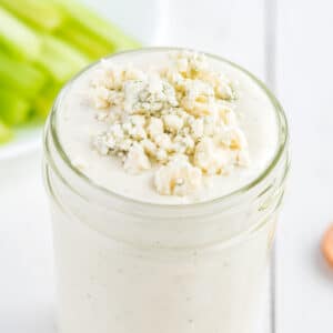 Blue cheese dressing with blue cheese crumble in a mason jar.