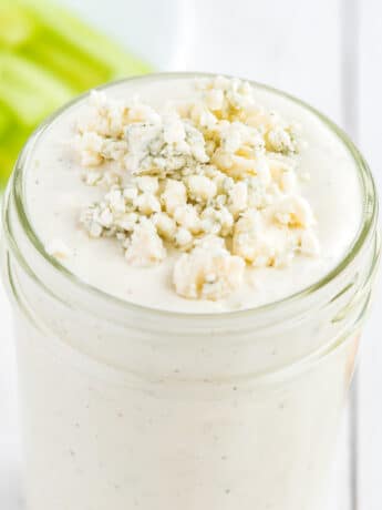 Blue cheese dressing with blue cheese crumble in a mason jar.