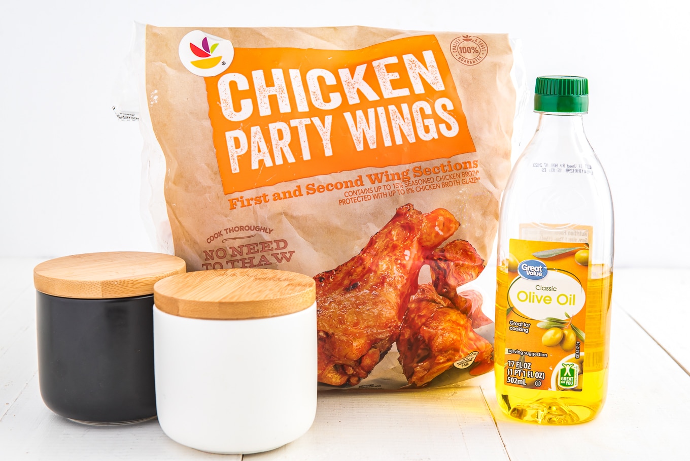 Ingredients displayed for air fryer chicken wings, slat pepper, frozen wings, and olive oil. 