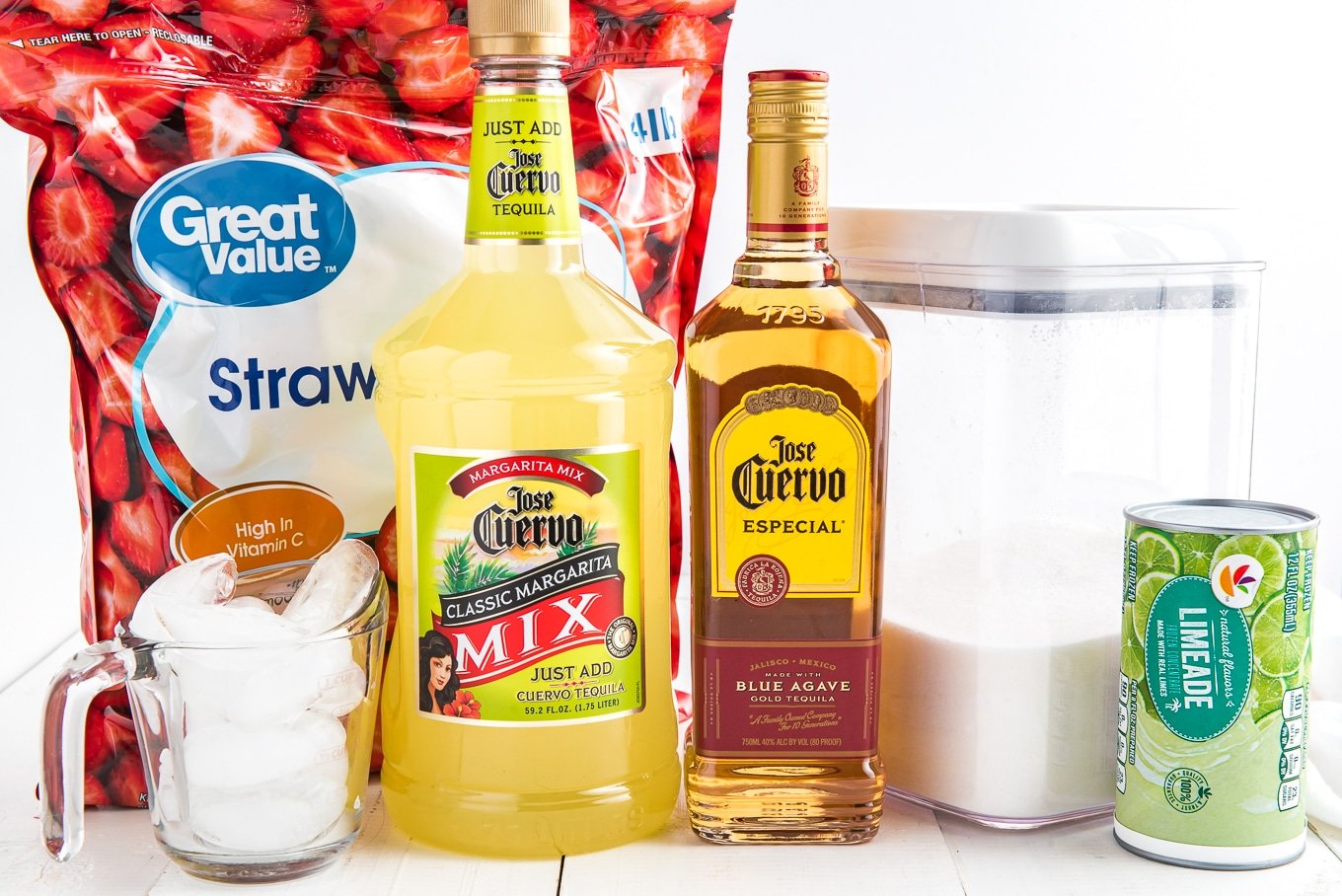 Ingredients to make frozen strawberry margaritas on the table.