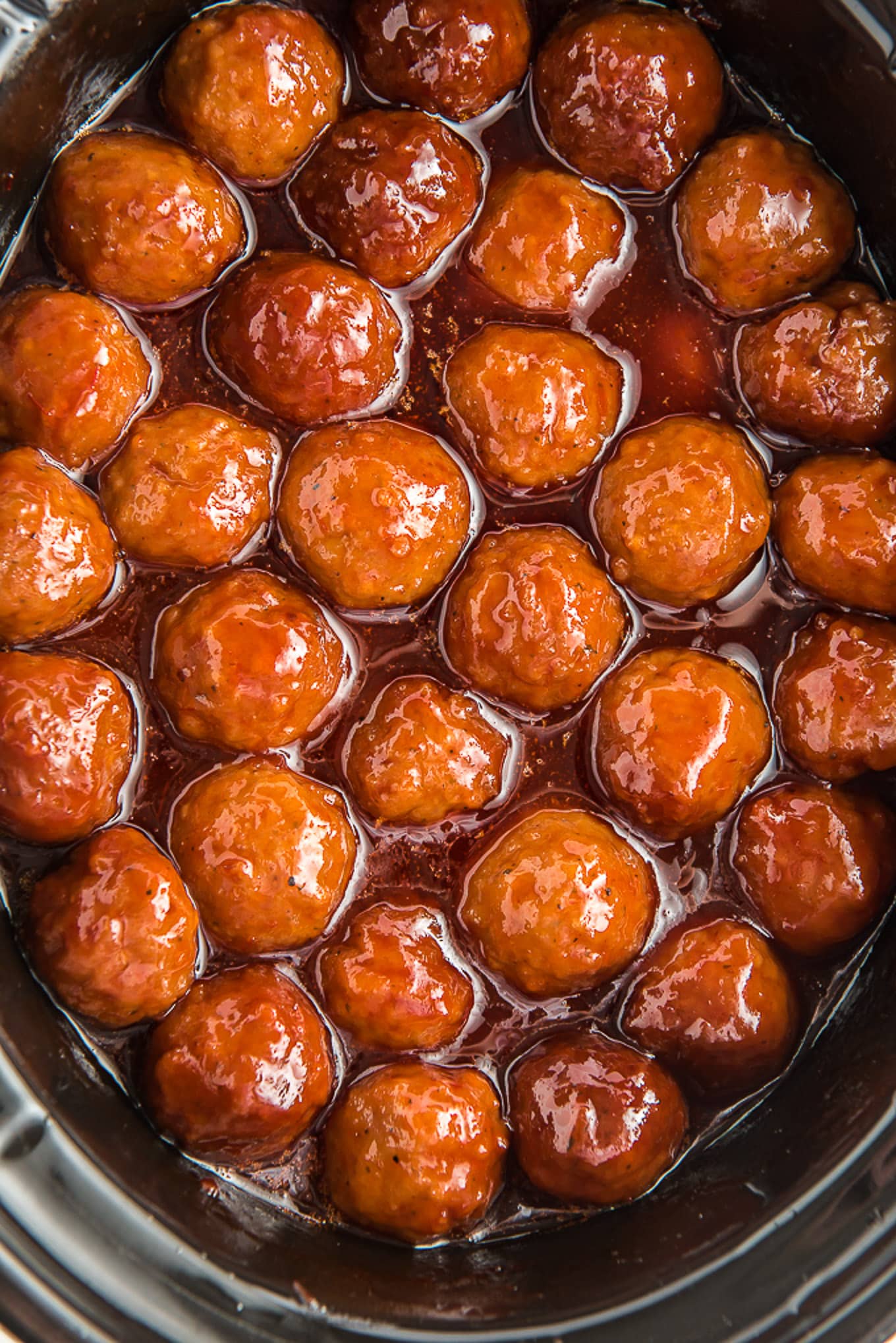Meatballs in sauce in a crockpot.