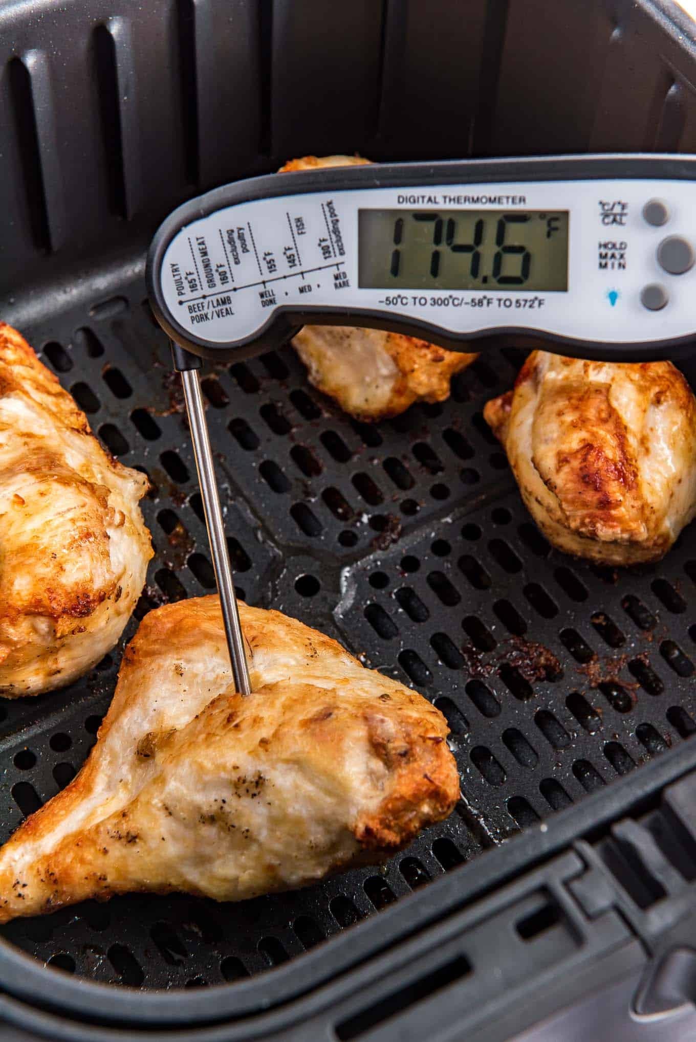 Checking the internal temperature of the chicken breasts. 