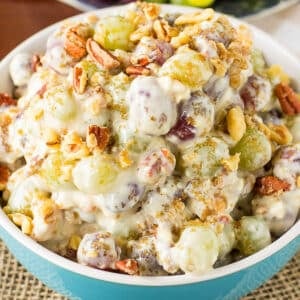 Grape salad with brown sugar and pecan topping in a bowl on the table.