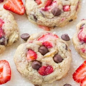 Strawberry cookies with chocolate chips on a baking tray.