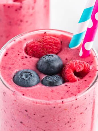 Breakfast energy smoothie on the table in a glass with fresh berries on top.