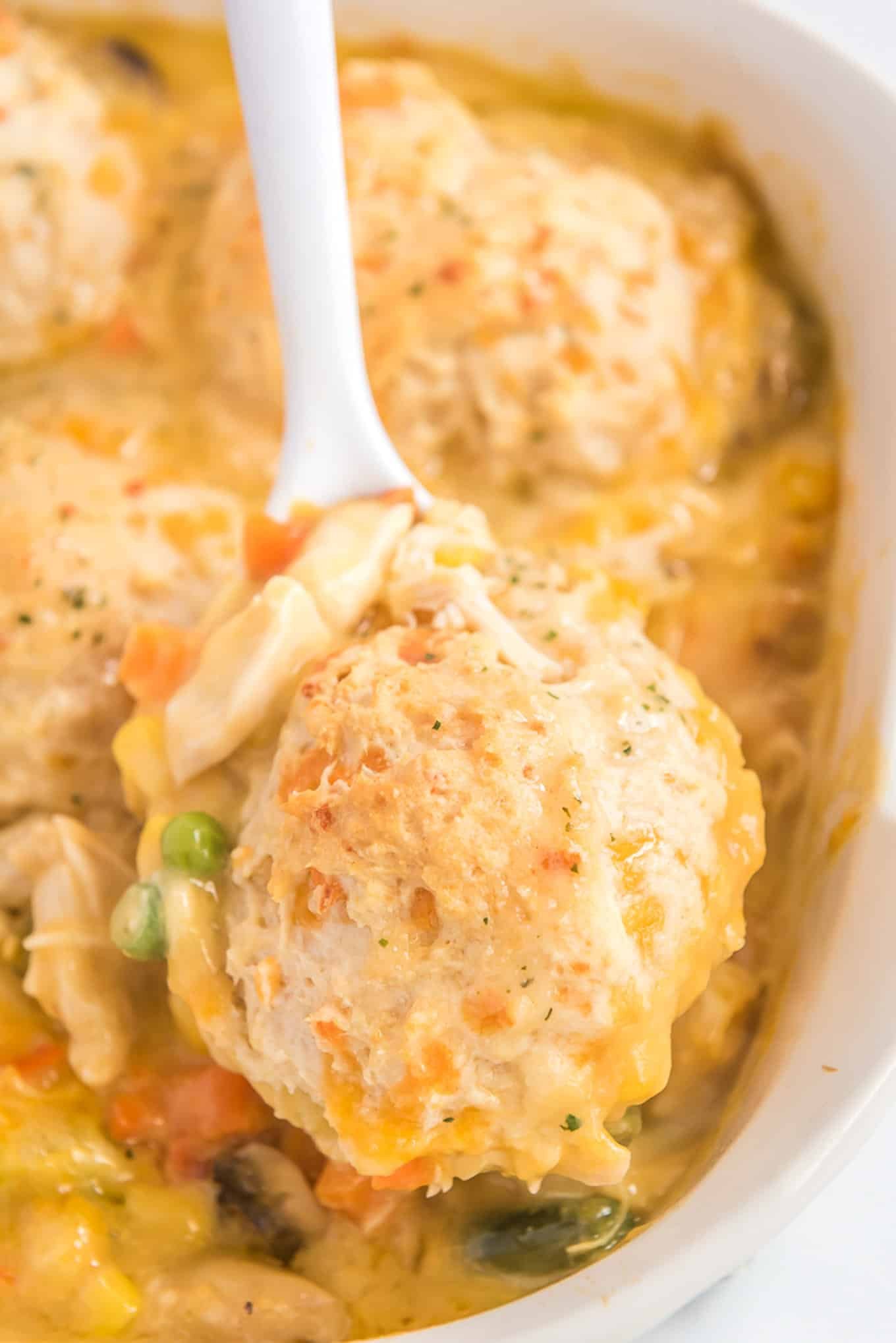 Scooping out chicken pot pie with a spoon.