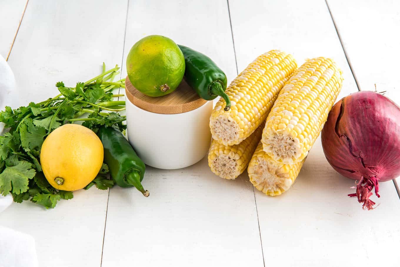 Ingredients to make fresh corn salsa on the table.