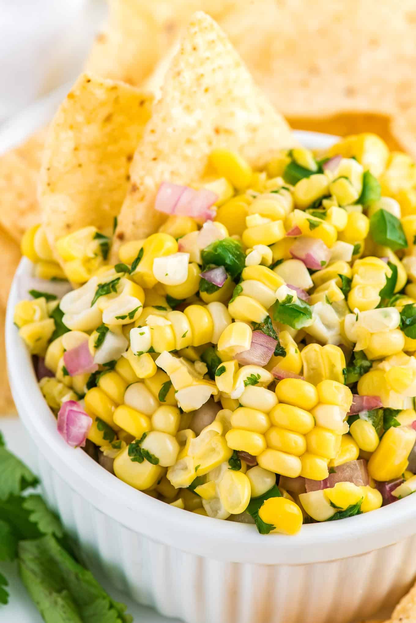 A closeup of a bowl of chipotle corn salsa on a the table.