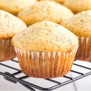 Lemon poppy seed muffins on a cooling rack.