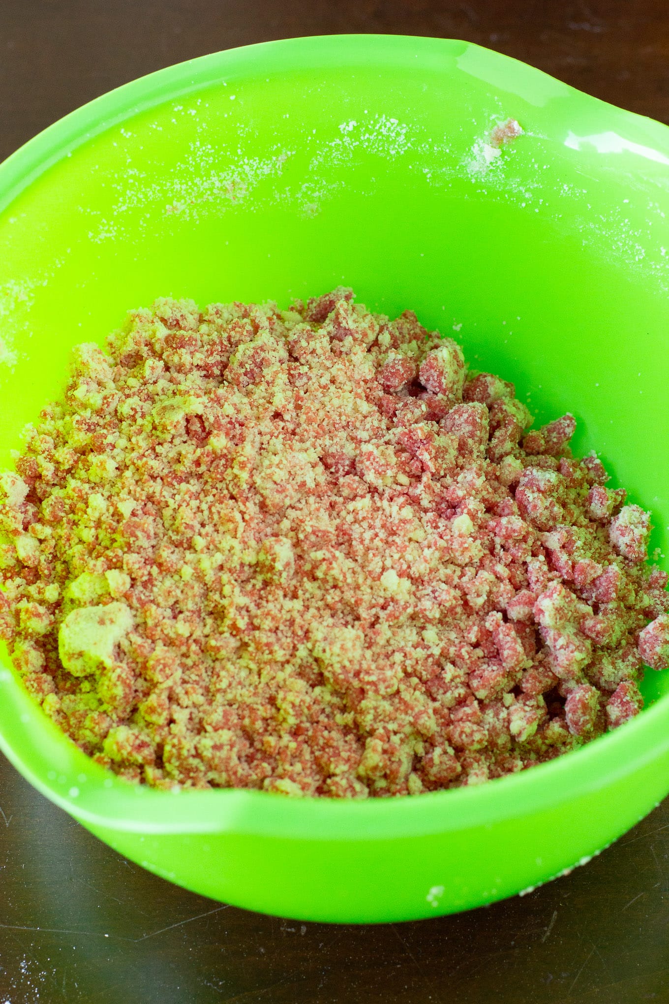 Crumble being mixed in a mixing bowl. 