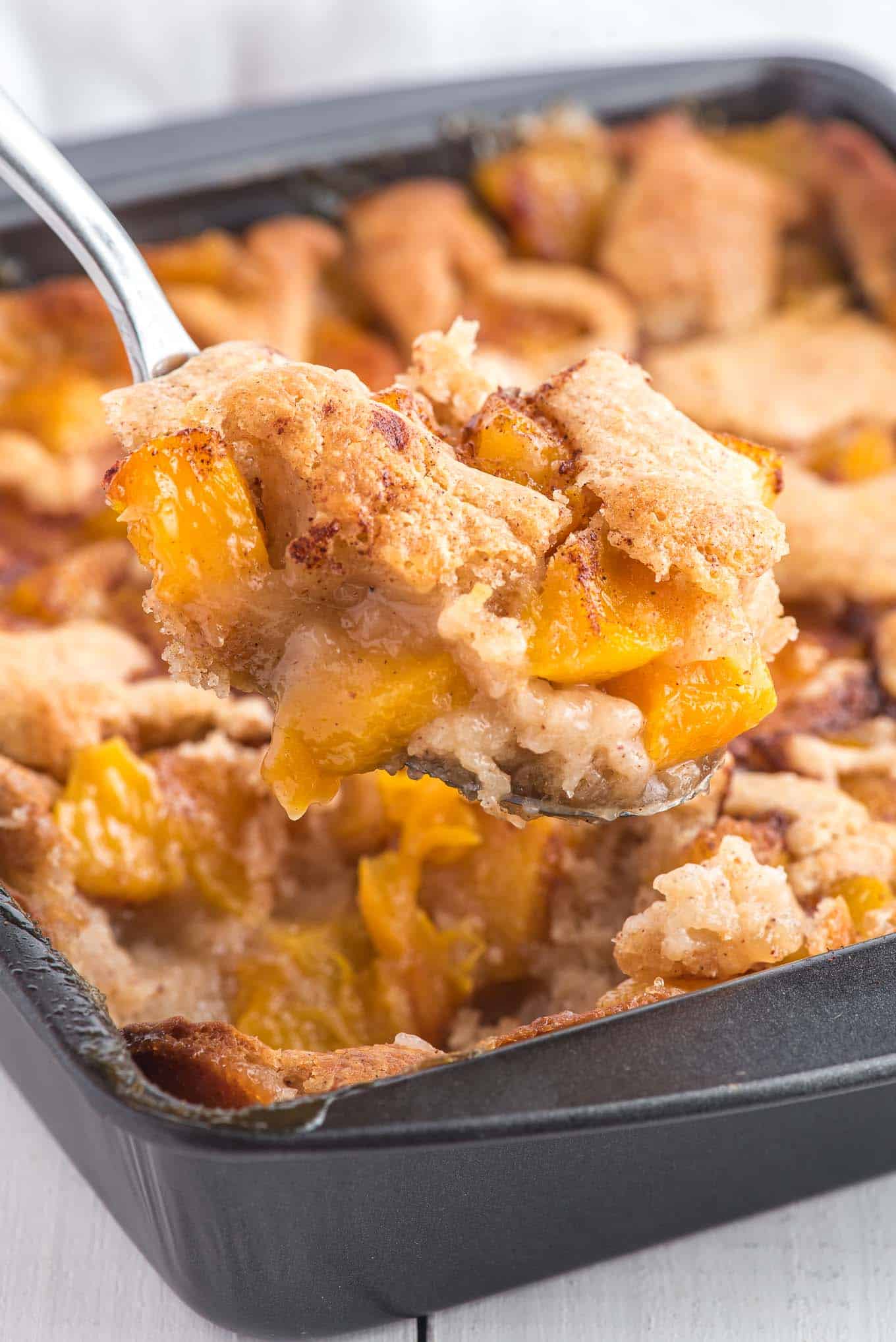 scoop of hot peach cobbler from the pan. 