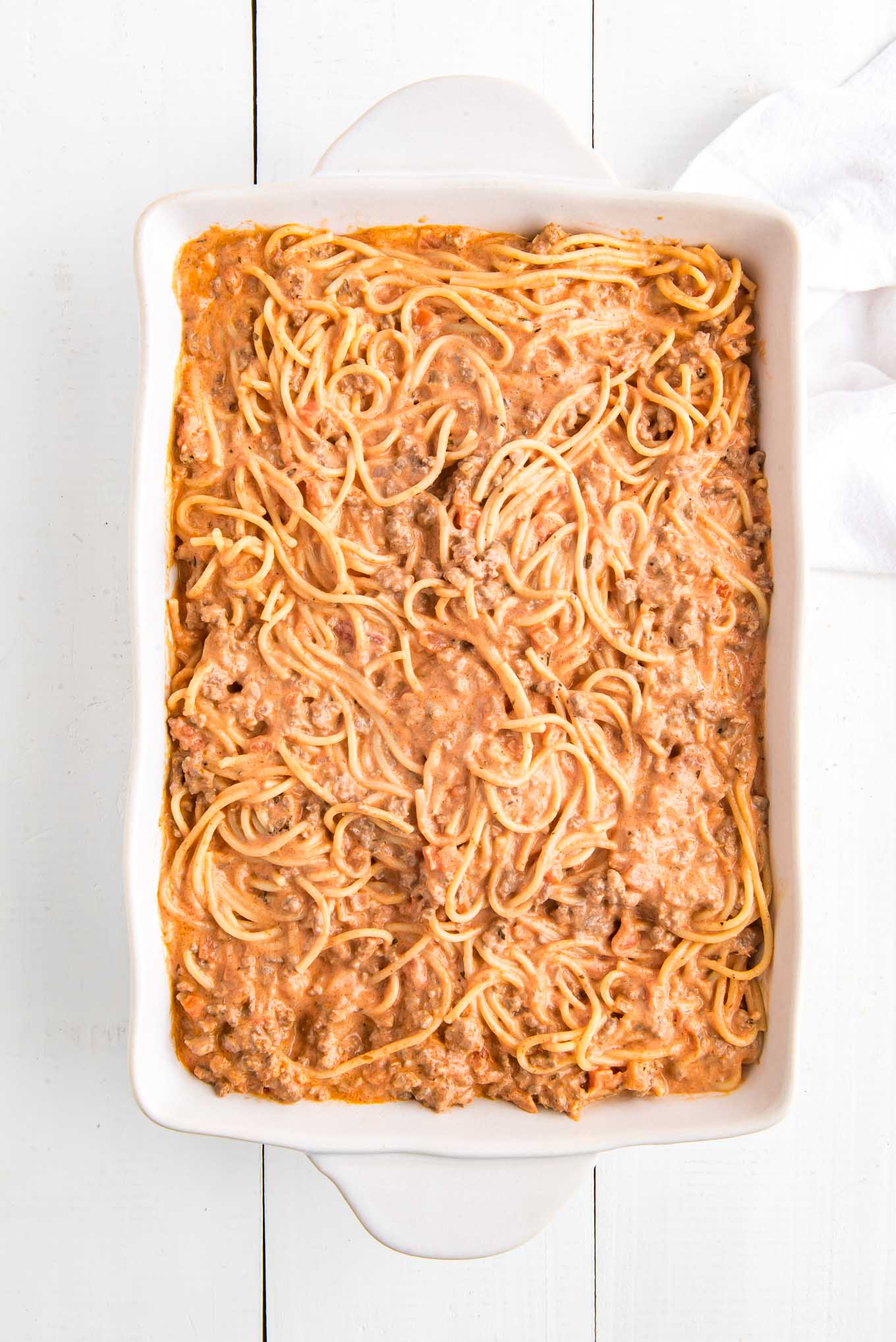 Spaghetti and meat sauce in a casserole dish.