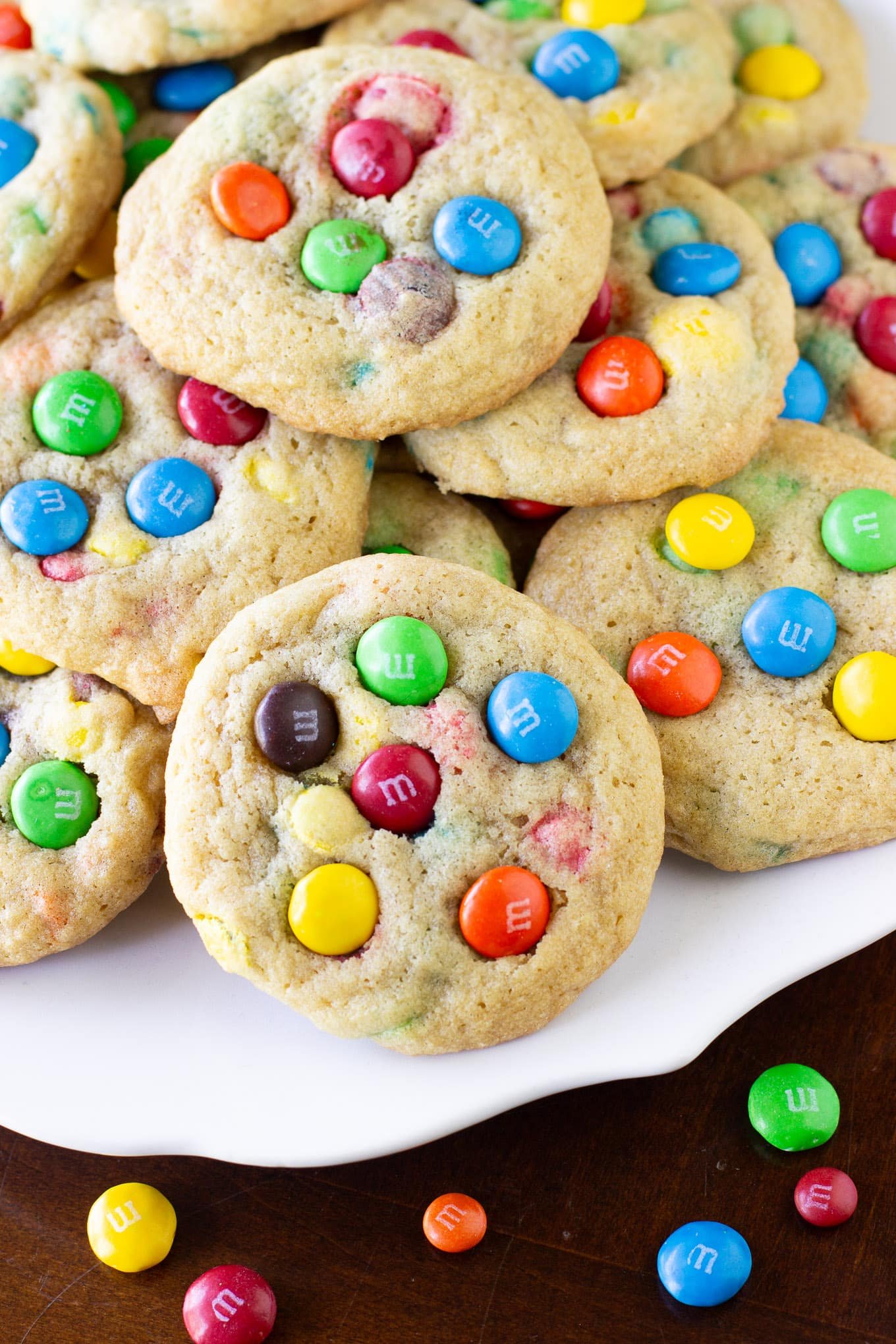 A pile of M&M cookies on a platter.