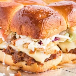 A closeup of a pulled pork slider with coleslaw on the table.