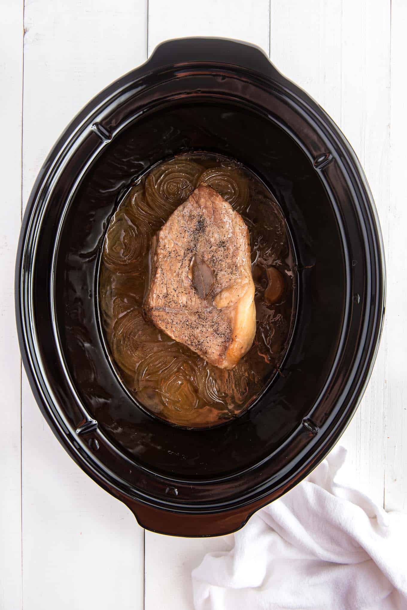 Beef roast in a slow cooker after cooking.
