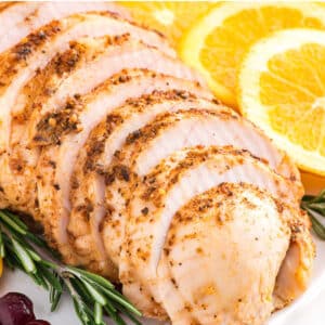 Boneless turkey breast roasted in the oven and served up sliced on a platter.