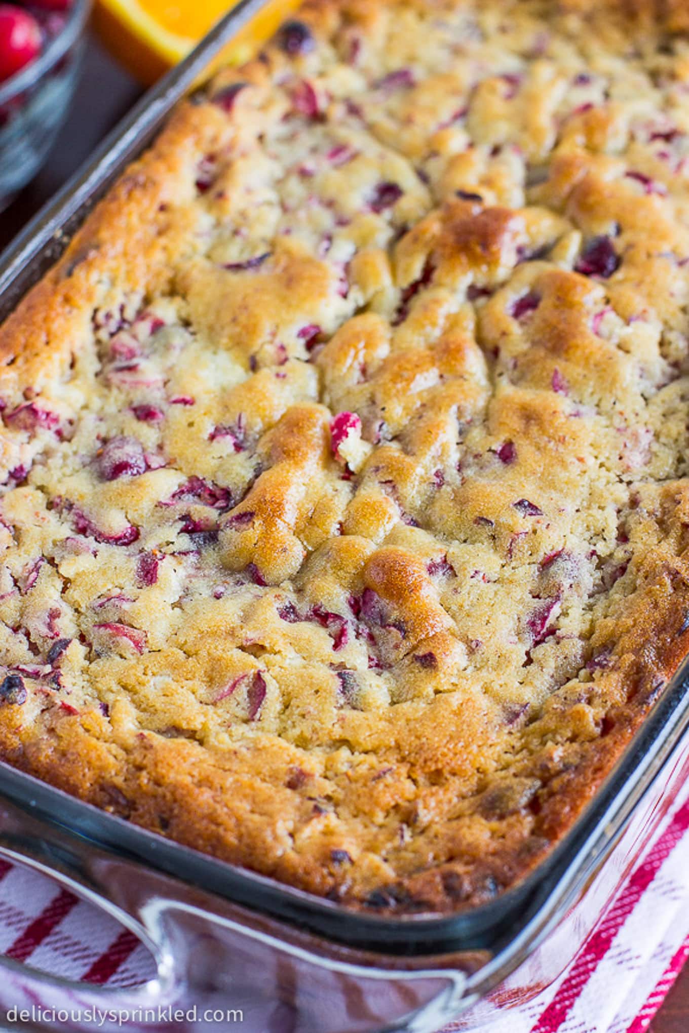 The top of a cranberry orange loaf cake after baking in the oven.