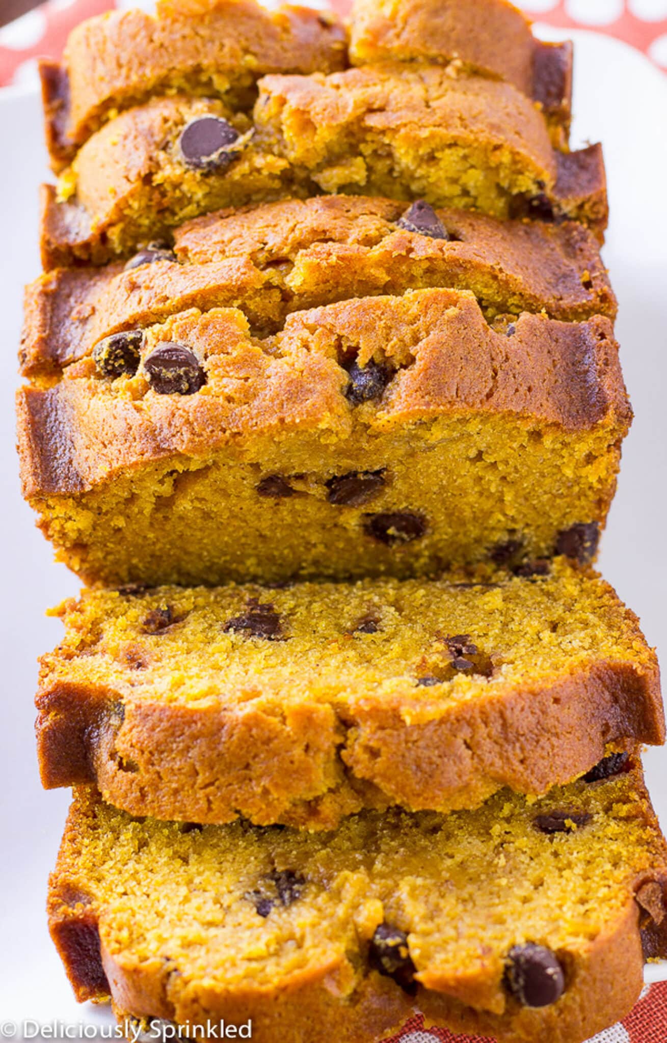 Overhead shot of pumpkin chocolate chip bread cut into slices and a few leaning over to the side.