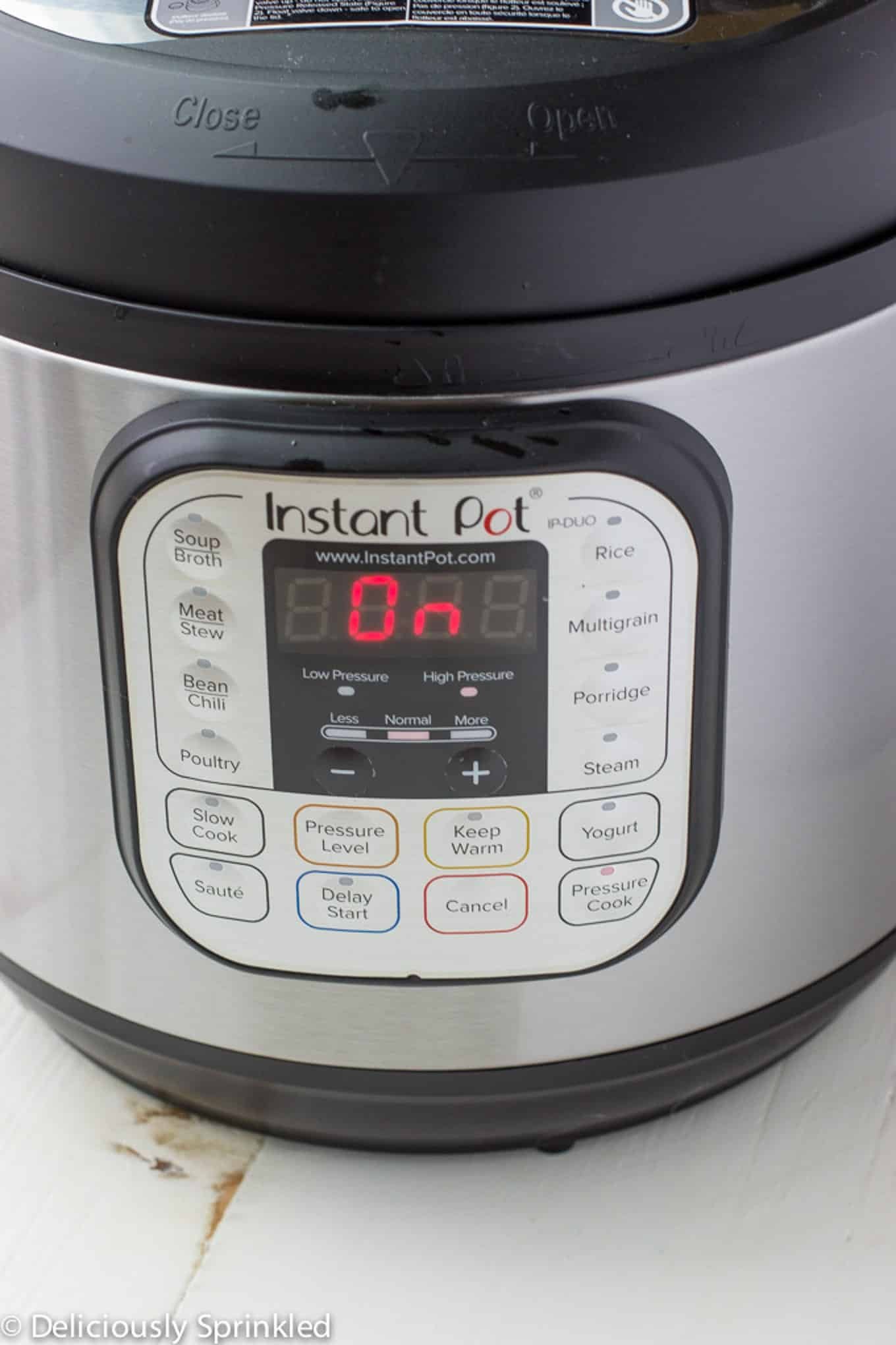 The instant pot with the time set and On.