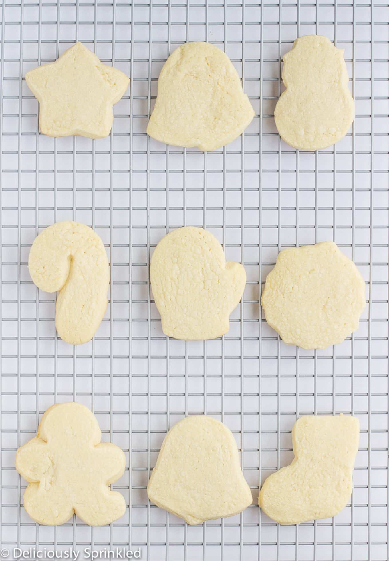 Baked sugar cookie cut-out cookies on a rack to cool.