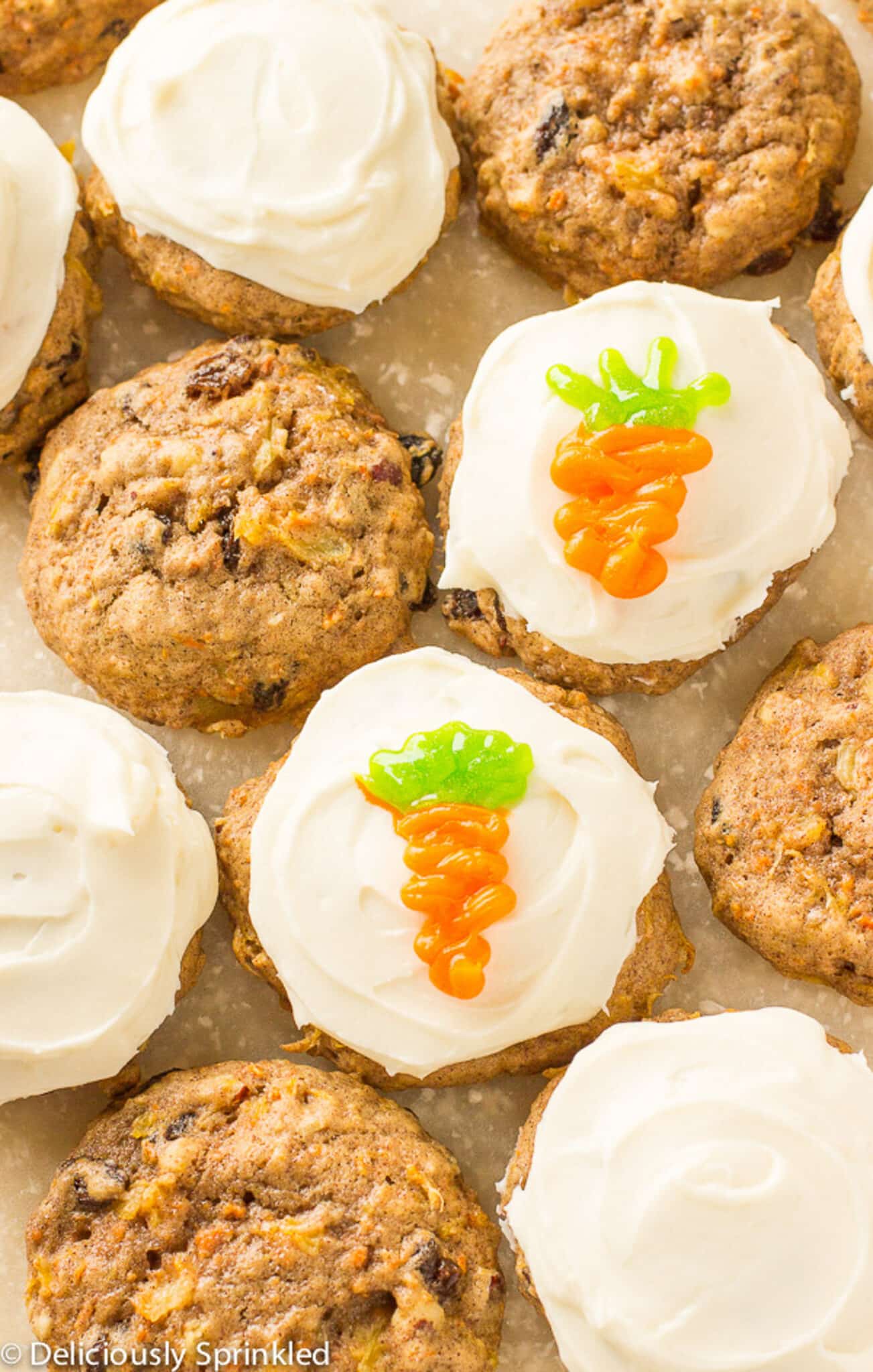 Sheet pan with frosted and unfrosted carrot cake cookies on it. 