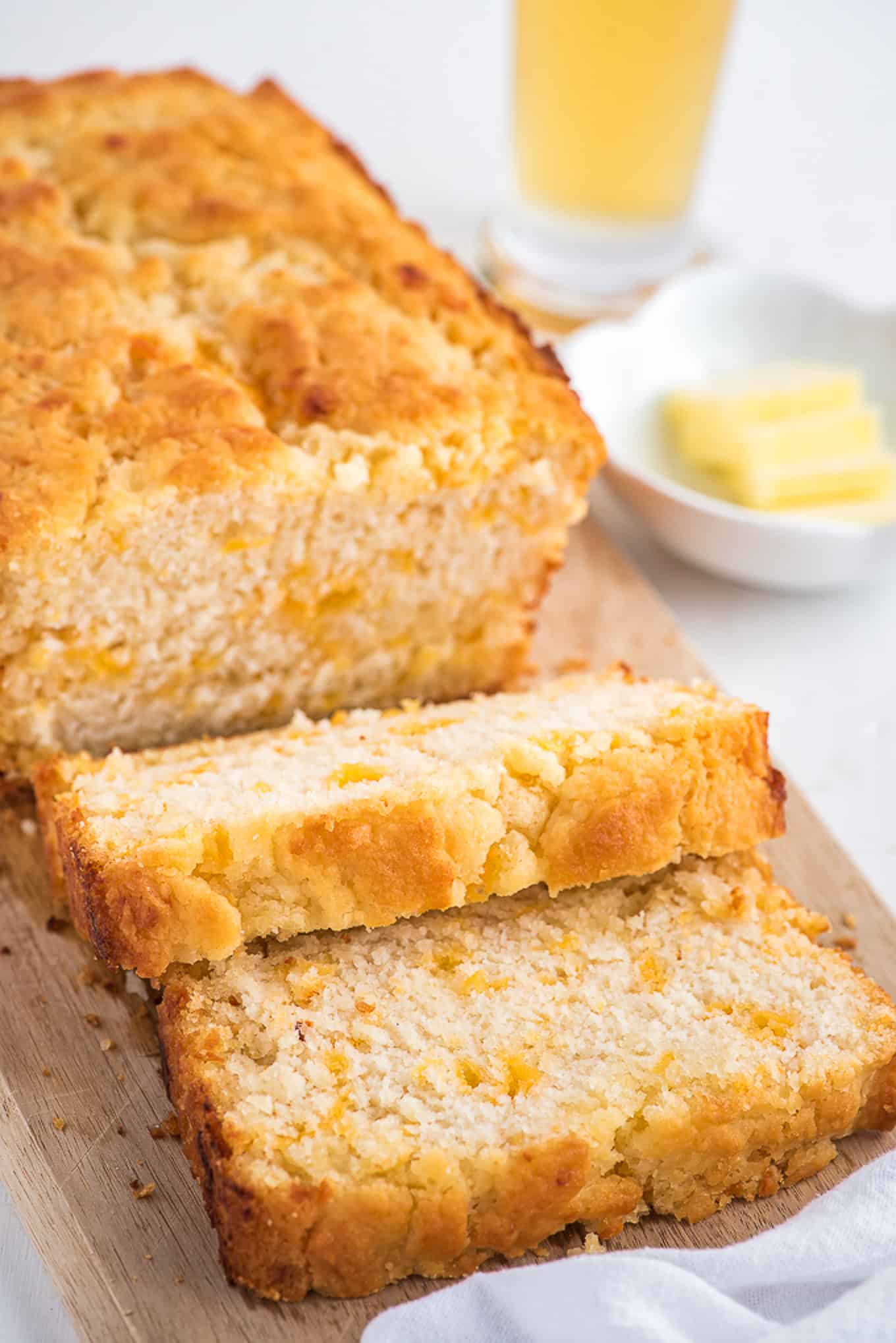 Loaf of cheesy beer bread cut into slices. 
