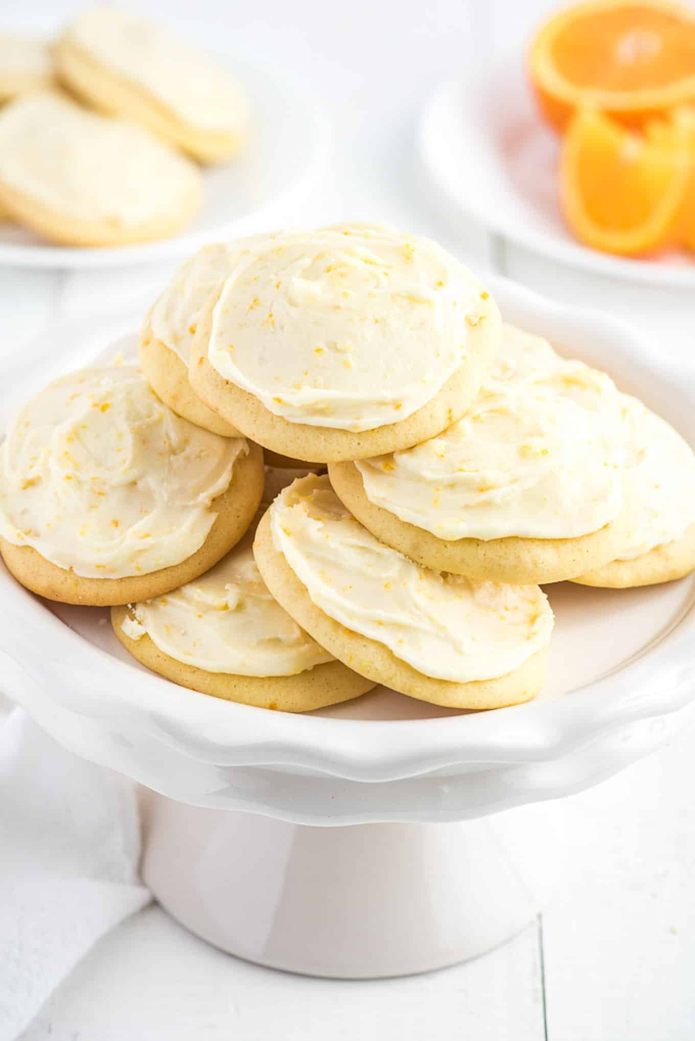 Frosted orange creamsicle cookies on a platter. 