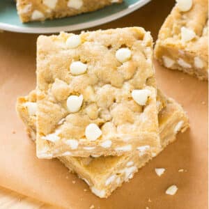 An overhead picture of white chocolate blondies stacked on top of each other.