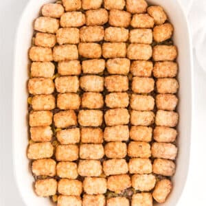 Easy tater tot casserole in a white casserole dish on the table.