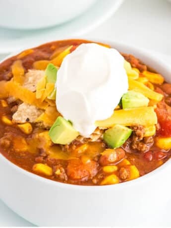 Bowl of chili topped with extra toppings.