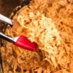 Crockpot salsa chicken being served from a crockpot.